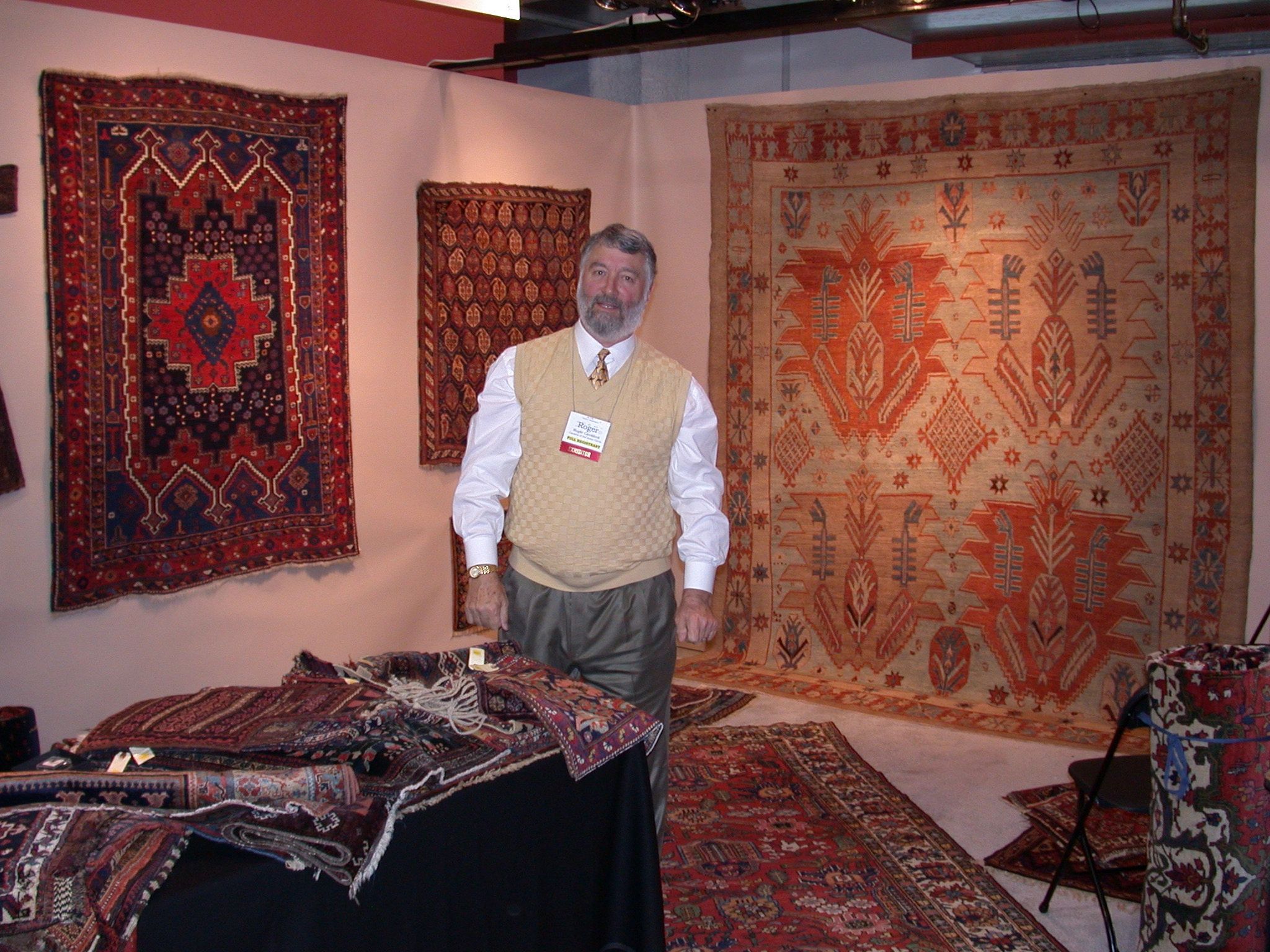 Carpets of the Inner Circle at a tribal arts show, surrounded by antique rugs
