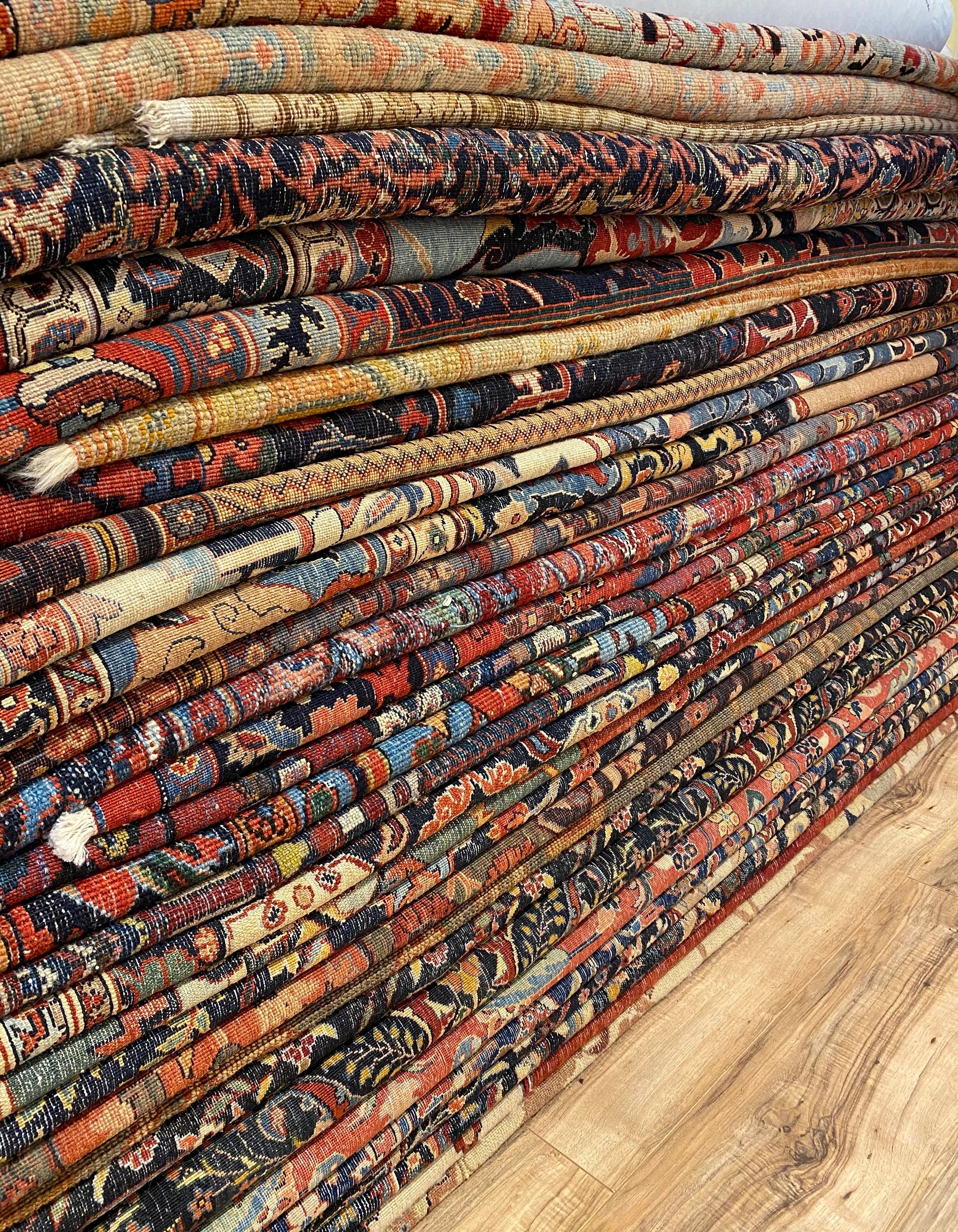 Rolled handmade rugs ready for detailed photos, video review, and insured national shipping