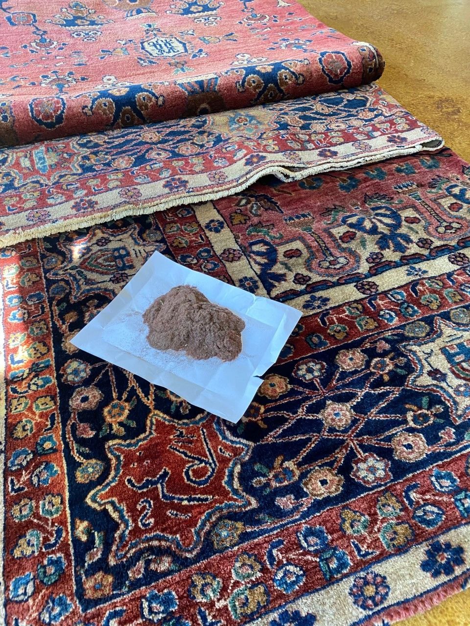 Embedded dust removed from a handmade rug before washing